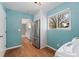 Kitchen with stainless steel refrigerator and view into a laundry room at 411 S Cody Ct, Lakewood, CO 80226