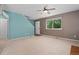 Open-concept living room with large windows and neutral carpet flooring at 411 S Cody Ct, Lakewood, CO 80226