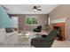 Inviting living room featuring a fireplace, large window, and comfortable seating at 411 S Cody Ct, Lakewood, CO 80226