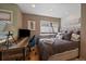 Cozy bedroom featuring a wooden desk, large window, and comfortable bed with plush pillows and throws at 350 Arapahoe Ave # 17, Boulder, CO 80302