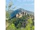 Picturesque view of mountain landscape with rock formations and abundant trees at 350 Arapahoe Ave # 17, Boulder, CO 80302