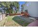 Large backyard featuring a wooden fence, grass, a patio with a gazebo, and exterior home features at 18899 E Whitaker Cir, Aurora, CO 80015