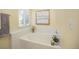 Soaking tub is surrounded by white tile and features natural light at 18899 E Whitaker Cir, Aurora, CO 80015