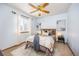 Bright bedroom features a ceiling fan, window and warm natural light at 18899 E Whitaker Cir, Aurora, CO 80015