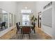 Bright dining room with vaulted ceilings, a large window and a modern table at 18899 E Whitaker Cir, Aurora, CO 80015