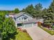 Charming two-story home with a well-maintained lawn, mature trees and a three-car garage at 18899 E Whitaker Cir, Aurora, CO 80015