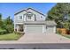 Charming two-story home with a well-maintained lawn, mature trees and a three-car garage at 18899 E Whitaker Cir, Aurora, CO 80015