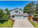 Charming two-story home with a well-maintained lawn, mature trees and a three-car garage at 18899 E Whitaker Cir, Aurora, CO 80015
