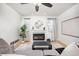 Cozy living room featuring a fireplace, neutral decor and a ceiling fan at 18899 E Whitaker Cir, Aurora, CO 80015