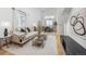 Bright living room with vaulted ceilings, modern decor and an open floor plan that leads to the dining room at 18899 E Whitaker Cir, Aurora, CO 80015