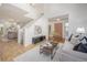 Bright living room with modern decor and an open floor plan that leads to the entry and stairs at 18899 E Whitaker Cir, Aurora, CO 80015