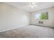 Large bedroom with window, ceiling fan, and plush carpeting at 605 S Alton Way # 9C, Denver, CO 80247