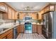 Well-equipped kitchen featuring wood cabinets and ample counter space at 605 S Alton Way # 9C, Denver, CO 80247