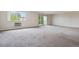 Spacious living room with balcony access and neutral carpeting at 605 S Alton Way # 9C, Denver, CO 80247