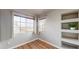 Cozy bedroom featuring two windows, shelving, and hardwood floors at 15800 E 121St Ave # L1, Brighton, CO 80603