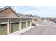 Row of detached garages with green doors and stone veneer at 15800 E 121St Ave # L1, Brighton, CO 80603