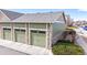 A row of green garages with stone accents and a nicely landscaped area at 15800 E 121St Ave # L1, Brighton, CO 80603