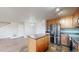 Kitchen area features stainless steel appliances, wood cabinetry, and a breakfast bar island at 15800 E 121St Ave # L1, Brighton, CO 80603