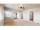 Bright and spacious main bedroom with neutral carpet, large window, and ceiling fan at 15800 E 121St Ave # L1, Brighton, CO 80603