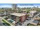 Aerial view of a multi-story red brick apartment building, close to Downtown Denver, surrounded by trees and buildings at 200 N Pearl St # 106, Denver, CO 80203