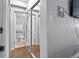 Hallway includes large mirrored closet doors and leads to a bathroom with a toilet, towel rack, and modern finishes at 200 N Pearl St # 106, Denver, CO 80203