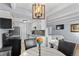 An open living area with dining area, kitchen, and bedroom featuring beamed ceilings at 200 N Pearl St # 106, Denver, CO 80203