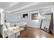 The primary bedroom has beamed ceilings, hardwood floors, and a marble topped end table at 200 N Pearl St # 106, Denver, CO 80203