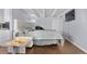 A cozy main bedroom with hardwood floors, beamed ceilings and stylish decor at 200 N Pearl St # 106, Denver, CO 80203