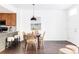 Dining area with a round table and four woven chairs at 16091 E Geddes Dr # 74, Aurora, CO 80016