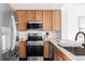 Modern kitchen with stainless steel appliances and light wood cabinets at 16091 E Geddes Dr # 74, Aurora, CO 80016