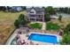Aerial view of an outdoor pool, landscaping, and a three-story home with outdoor decks at 9928 Bluestar Dr, Parker, CO 80138