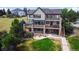 Aerial view of a three-story home with a large deck and a sprawling backyard at 9928 Bluestar Dr, Parker, CO 80138