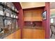 Stylish bar area with custom cabinetry, granite countertops, and decorative shelving at 9928 Bluestar Dr, Parker, CO 80138