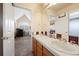 Spacious bathroom with double sinks, wood cabinets, and an open doorway to another room at 9928 Bluestar Dr, Parker, CO 80138