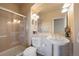 Bright bathroom featuring a tiled shower with glass door and pedestal sink at 9928 Bluestar Dr, Parker, CO 80138