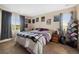 Bright bedroom with a comfortable queen-sized bed, decorative artwork, and carpeted floors at 9928 Bluestar Dr, Parker, CO 80138