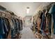 Long walk-in closet with ample hanging and shelving space for storage at 9928 Bluestar Dr, Parker, CO 80138