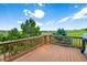 Spacious outdoor deck with wooden railings and an expansive view of the surrounding landscape at 9928 Bluestar Dr, Parker, CO 80138