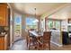 Bright dining room with a view, stylish lighting, and access to the deck at 9928 Bluestar Dr, Parker, CO 80138