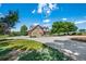 Beautiful home featuring a spacious driveway, stone and siding exterior, and mature trees at 9928 Bluestar Dr, Parker, CO 80138