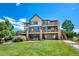 Expansive three-story home with a walkout basement, multiple decks, and lush lawn at 9928 Bluestar Dr, Parker, CO 80138