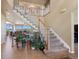 Grand foyer with a sweeping staircase, neutral colors, and tile flooring at 9928 Bluestar Dr, Parker, CO 80138