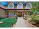 Inviting front porch with wooden pillars, stone accents, and well-manicured landscaping at 9928 Bluestar Dr, Parker, CO 80138