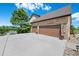 Attached three-car garage with stone accents and manicured landscaping enhance the curb appeal at 9928 Bluestar Dr, Parker, CO 80138