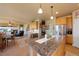 Spacious kitchen with granite island, stainless steel appliances, and open layout to the living room at 9928 Bluestar Dr, Parker, CO 80138