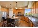 Charming kitchen features an island with seating, stainless steel appliances, and lovely countertops at 9928 Bluestar Dr, Parker, CO 80138