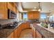 Modern kitchen with stainless steel appliances, granite countertops, and scenic views at 9928 Bluestar Dr, Parker, CO 80138