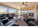 Bright living room features a stone fireplace, large windows, and an open floor plan at 9928 Bluestar Dr, Parker, CO 80138