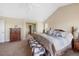 Bright and spacious main bedroom has a large bed and ensuite bathroom at 9928 Bluestar Dr, Parker, CO 80138