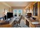 Well-lit office with custom built-ins, a spacious desk, and beautiful outdoor views at 9928 Bluestar Dr, Parker, CO 80138